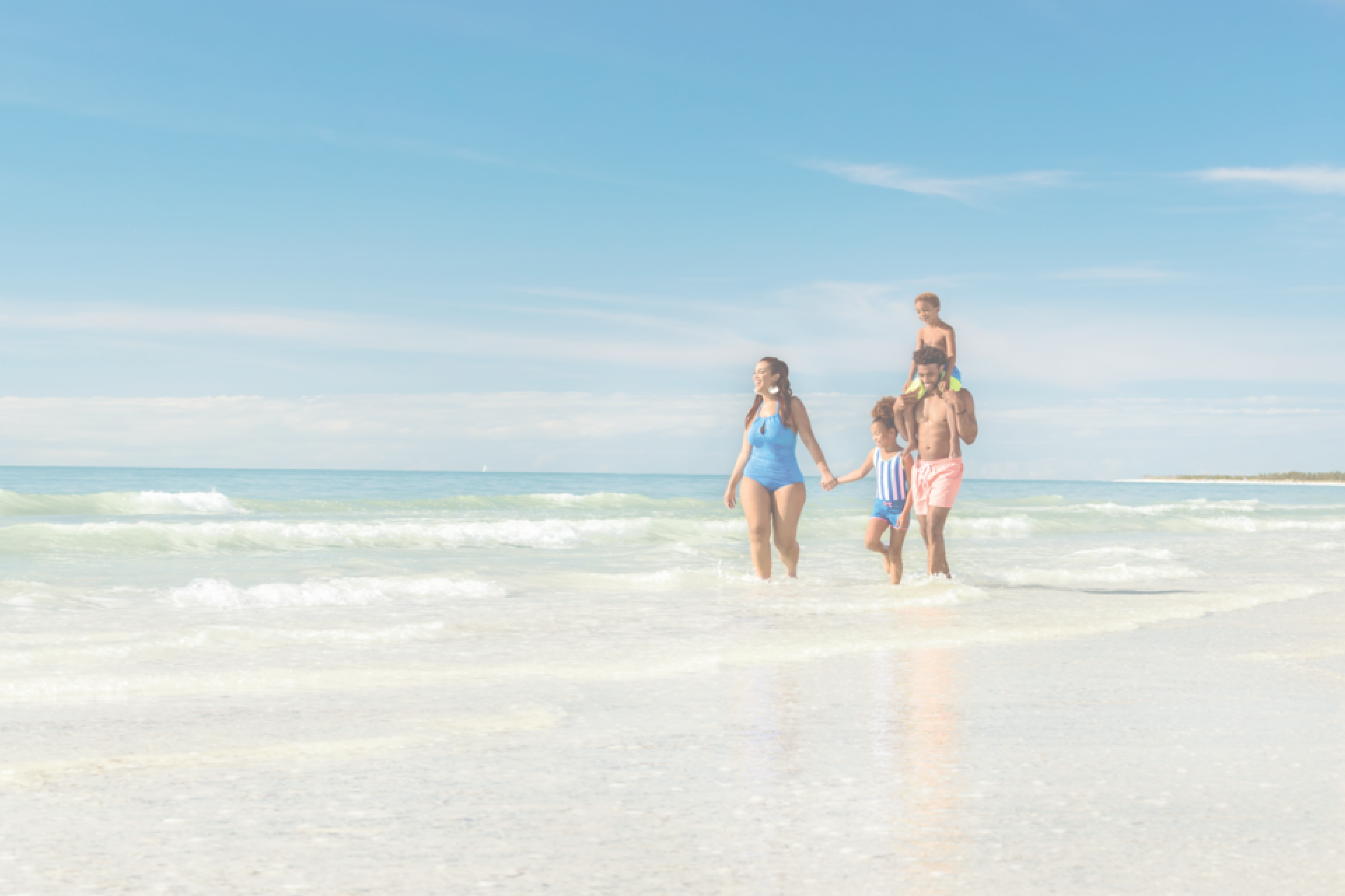 Family walking in ocean